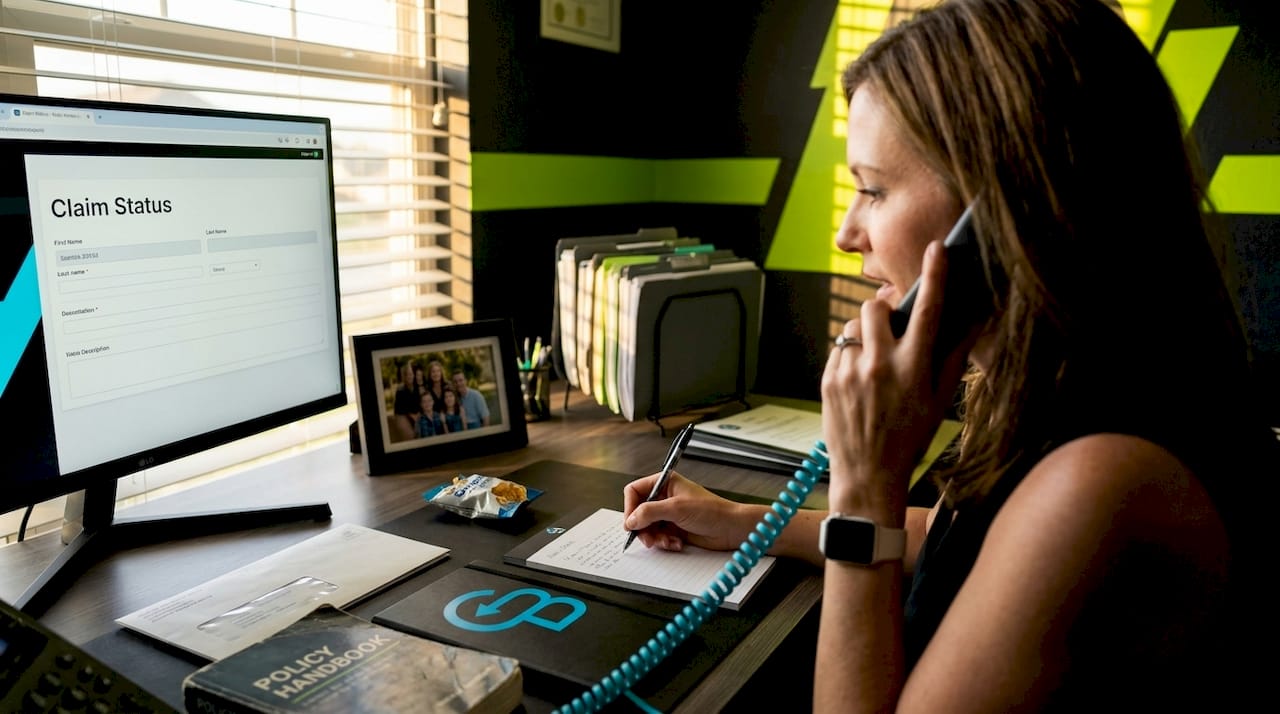 Agent discussing insurance claim on phone