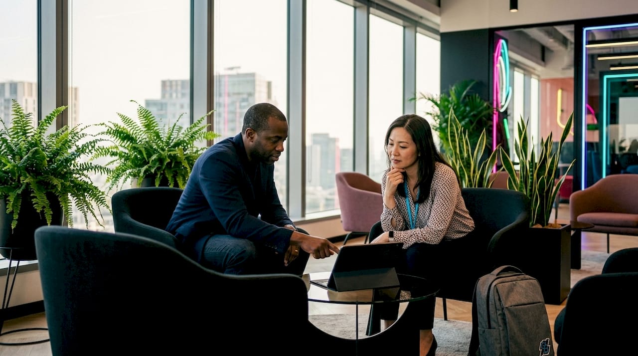 Colleagues discussing data charts in conference room