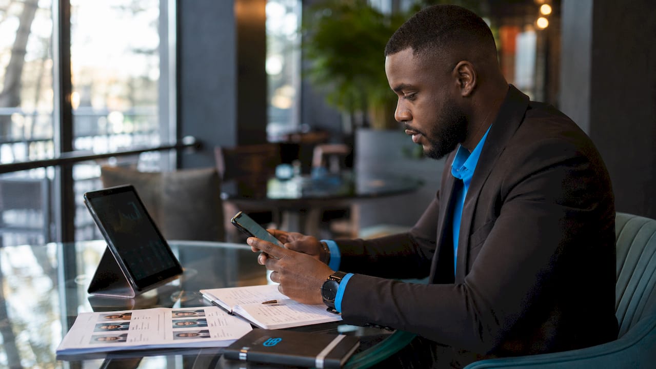 Hands using tablet and phone for personalized messaging