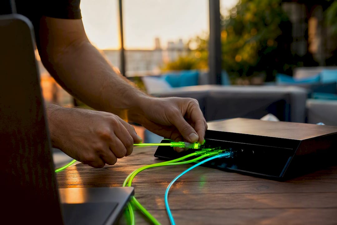 Hands connecting cables to network switch