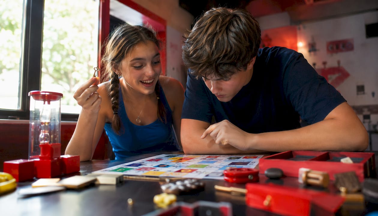 Siblings working on escape room puzzle