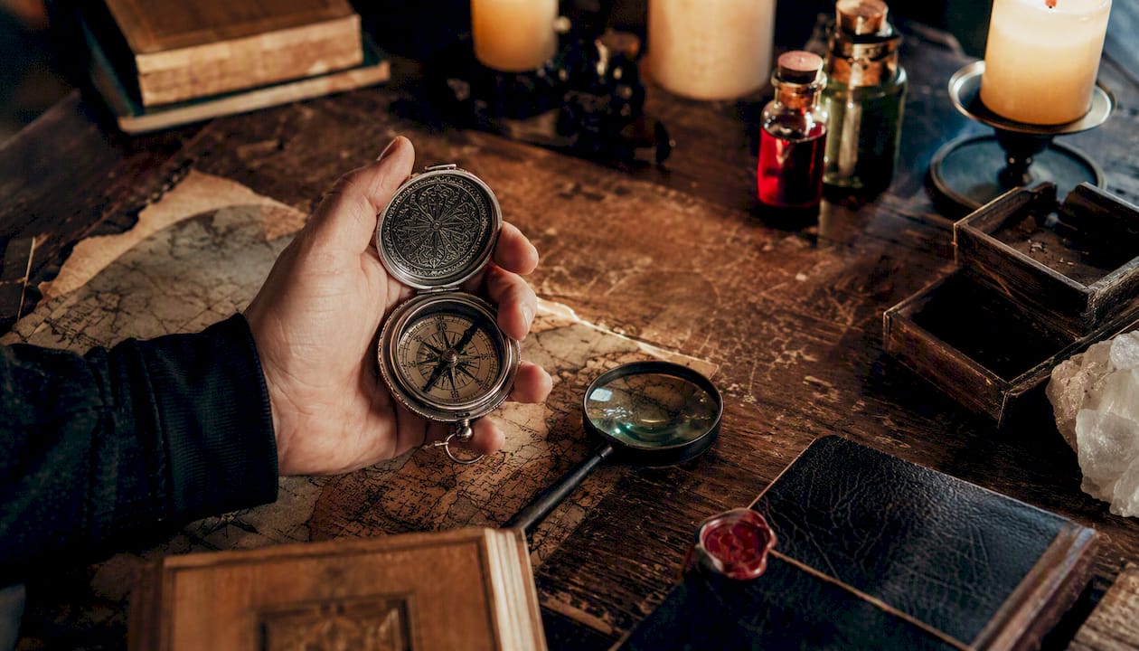 Hand holding brass key with sensory escape room props