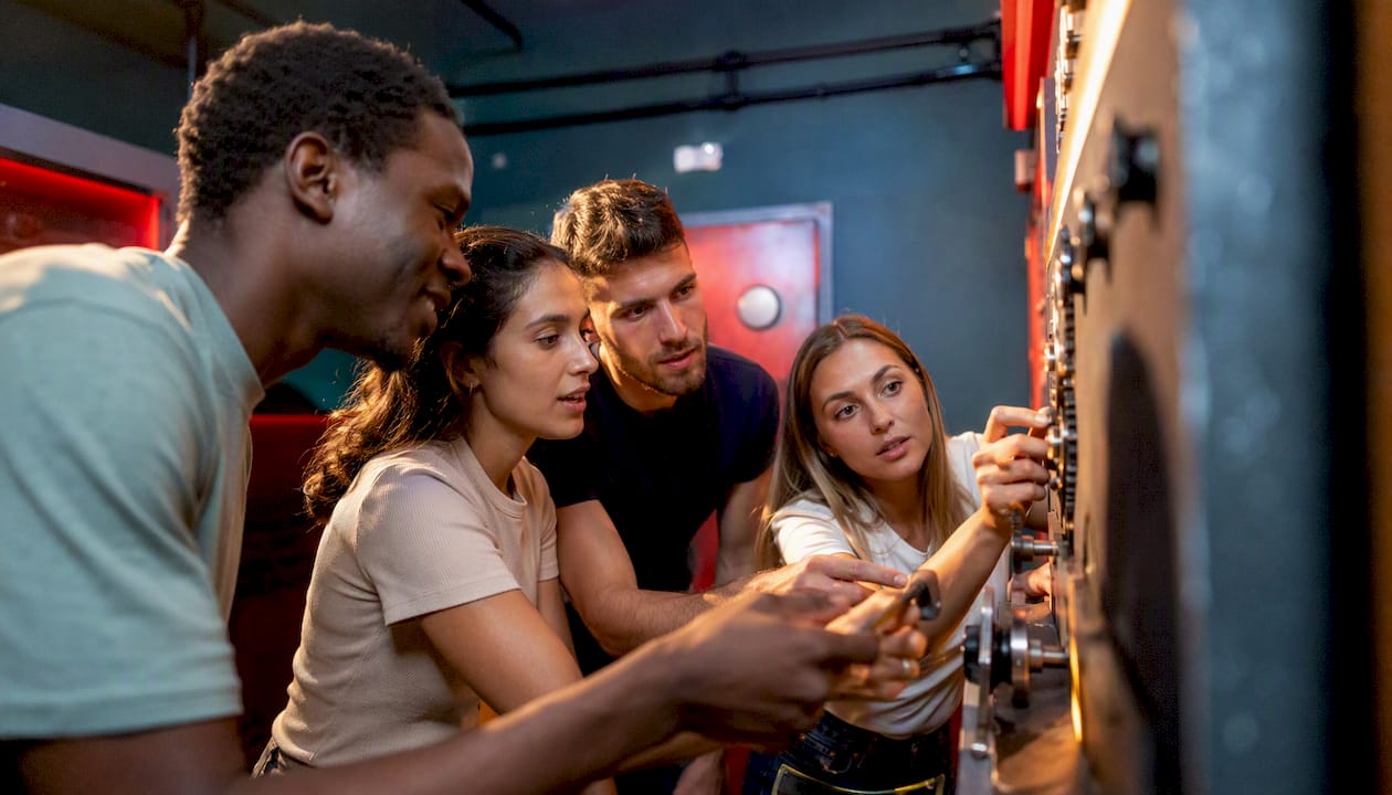 Hands interacting with puzzle pieces in escape room
