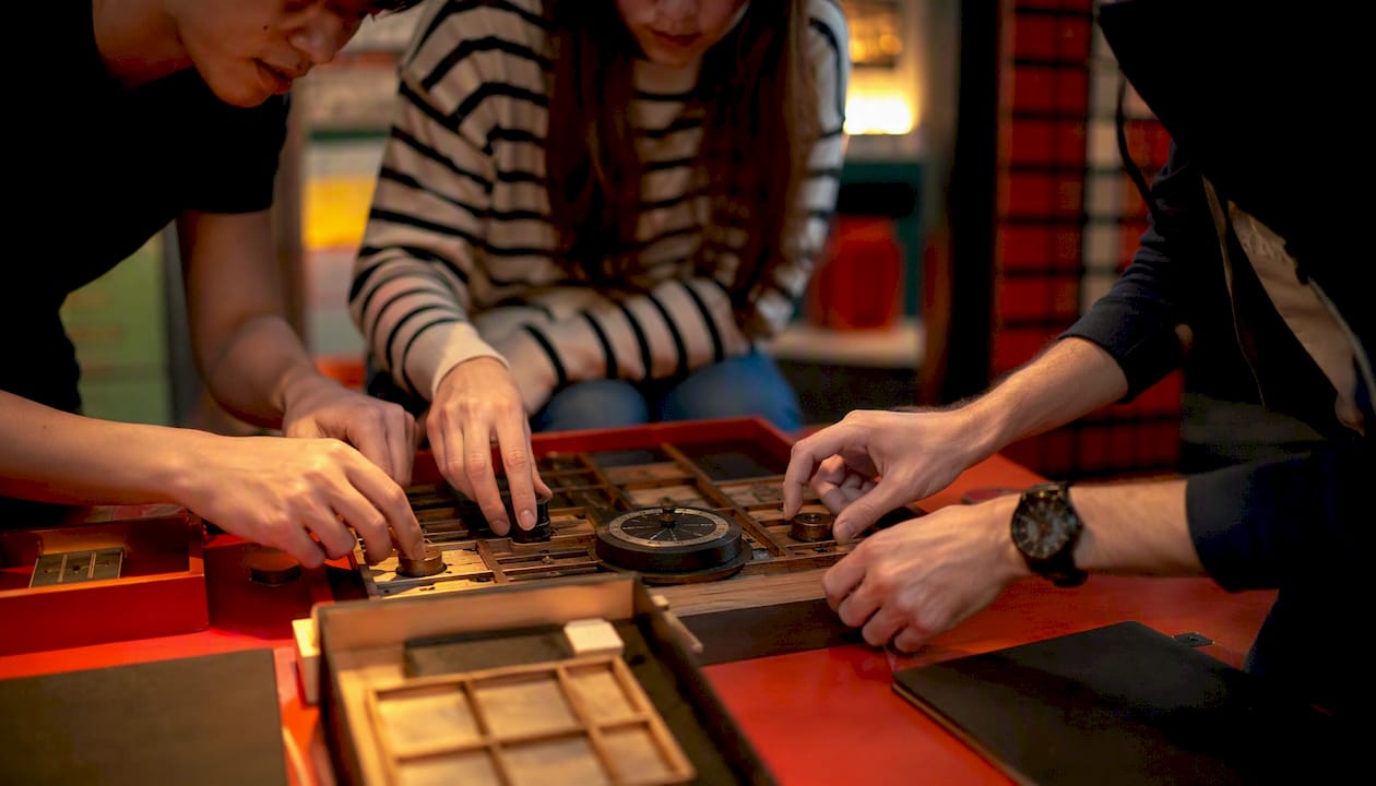 Hands solving escape room puzzle