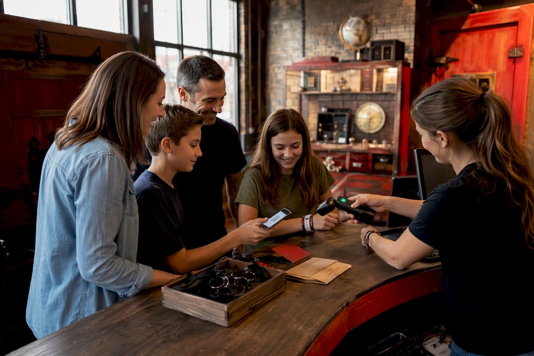 Hands scanning digital ticket at escape room check-in