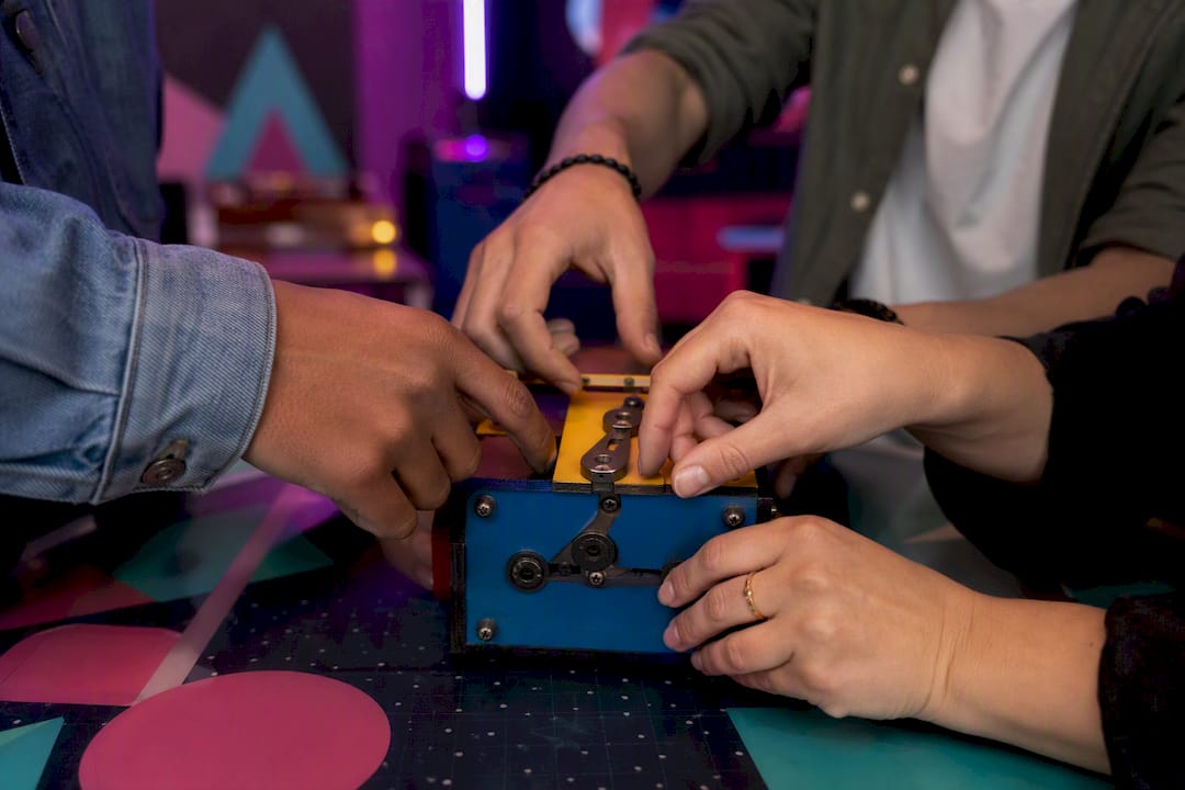 Team hands unlocking Japanese-style puzzle lock