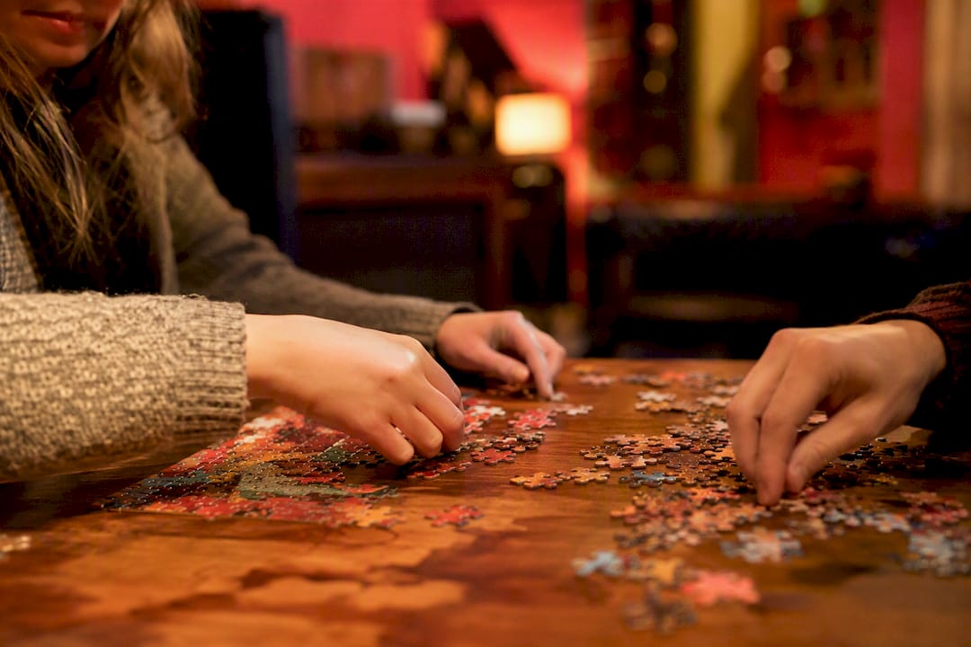 Close-up of colorful puzzle pieces with red accents