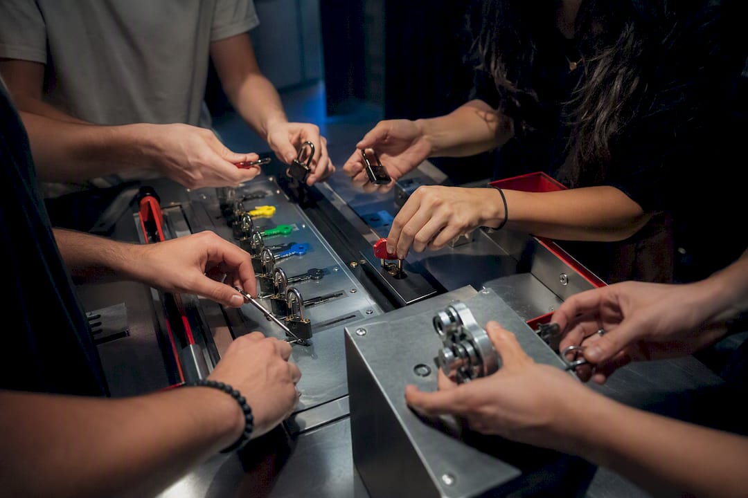 Hands manipulating escape room locks in private session
