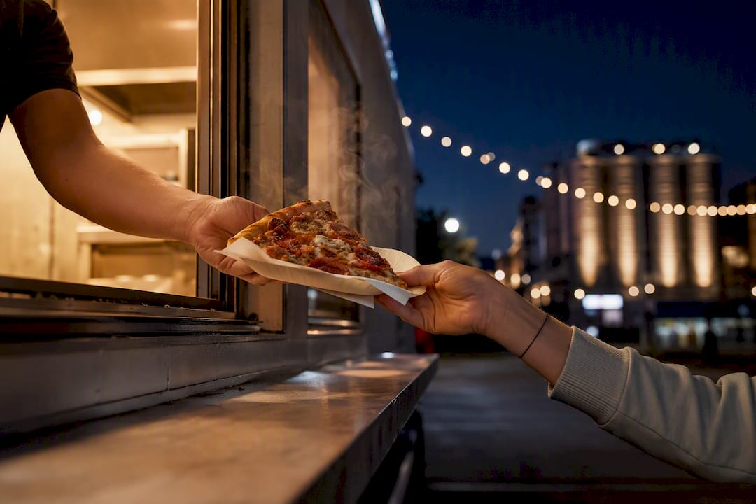 Pizza served from a food truck at night