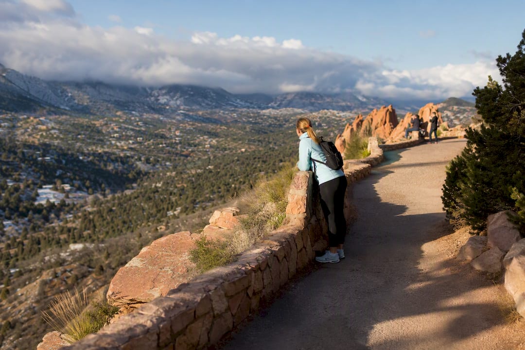 Quiet Colorado trail beneath changing clouds