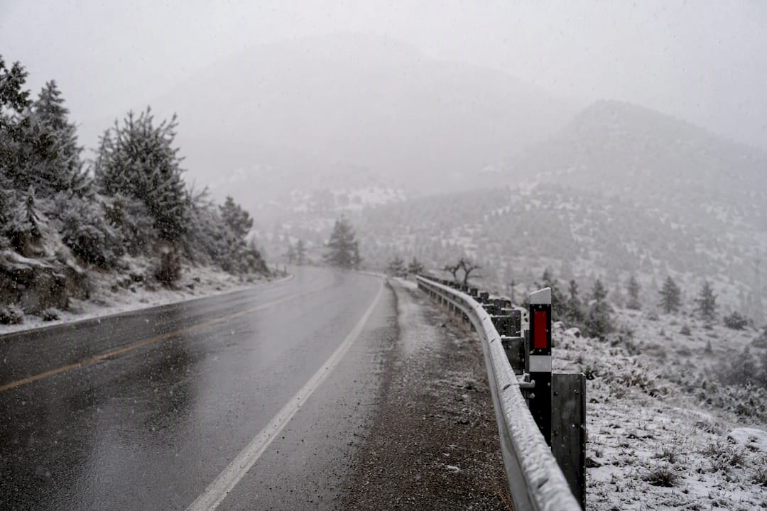 Snowy roadway showing unsafe travel weather