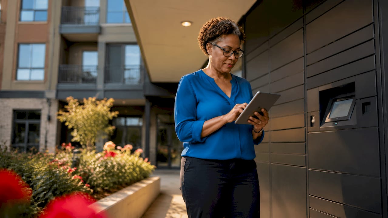 Property manager using smart locker in apartment lobby