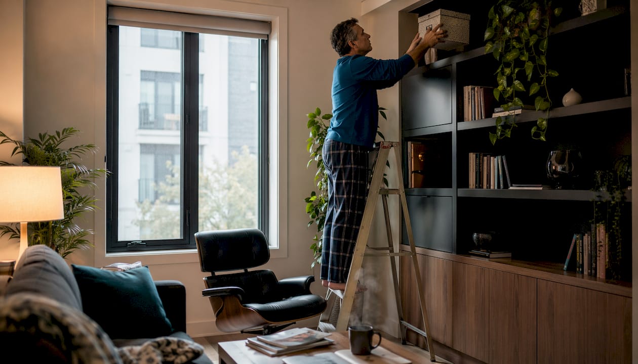 Man using vertical kitchen storage on step stool