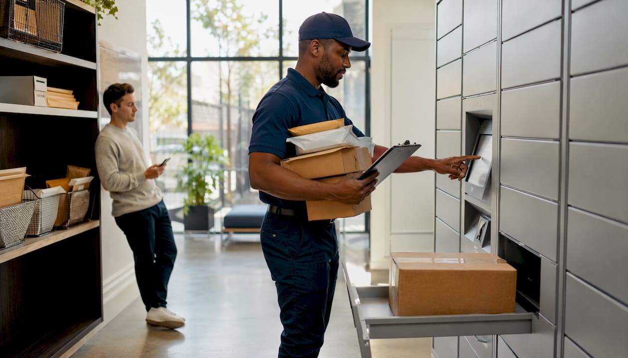 Delivery worker operating Parcel Pending locker in mailroom