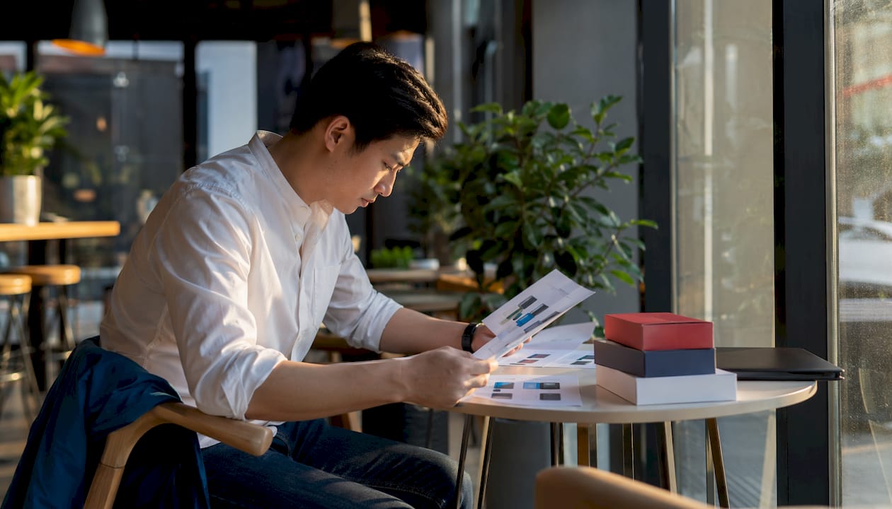 Man reviewing package box comparison charts