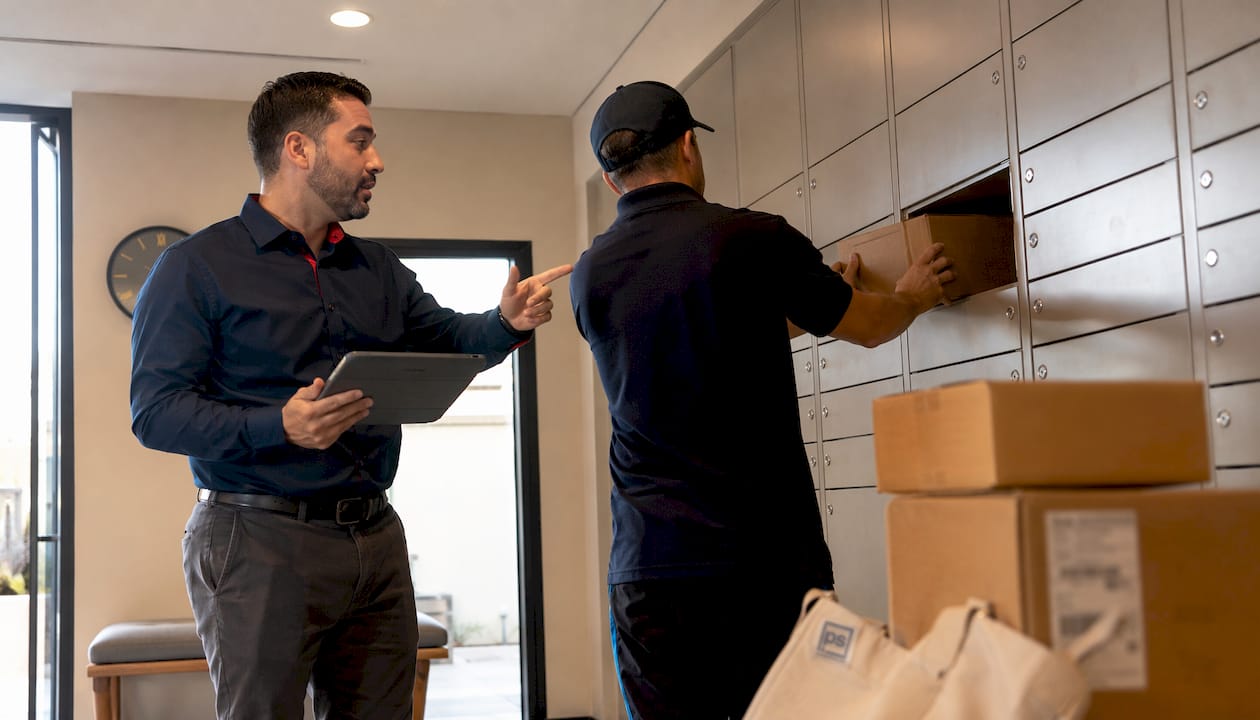 Live operator instructing delivery driver in package room