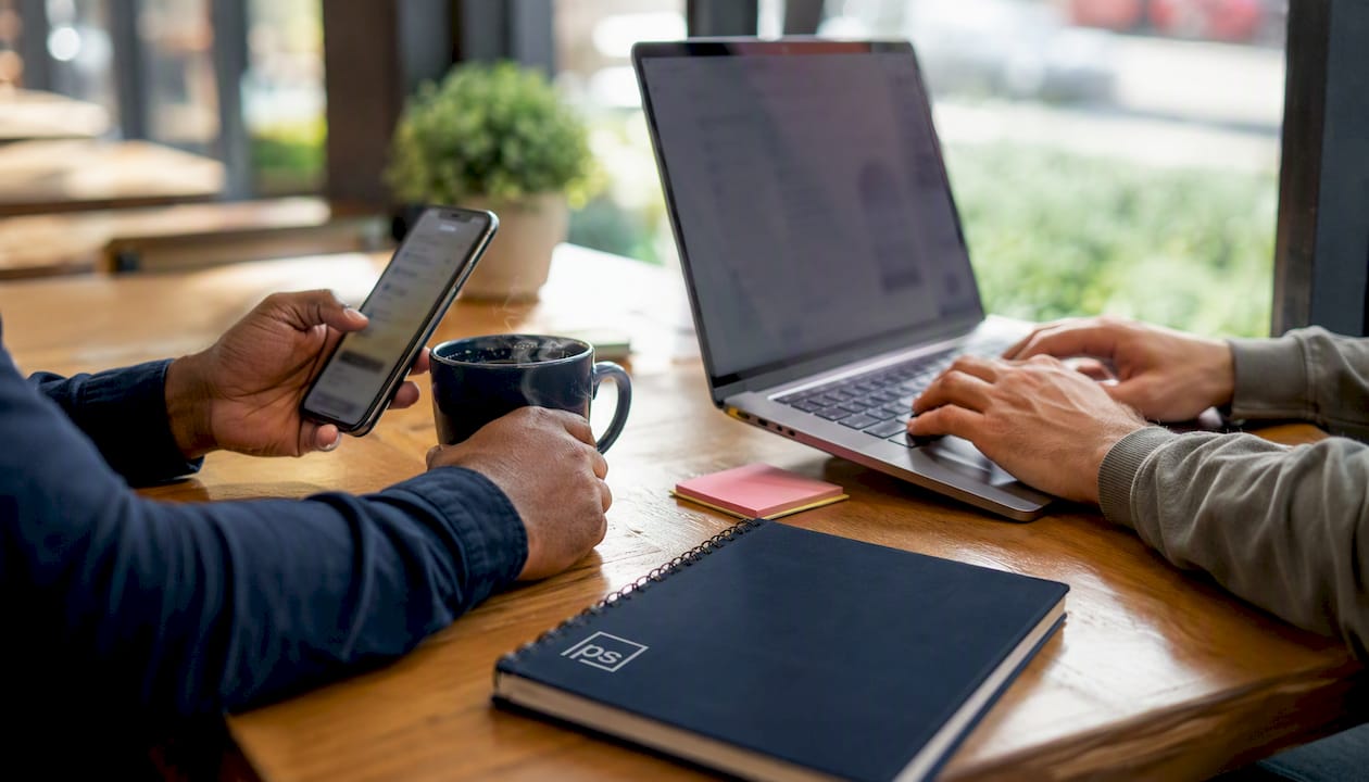 Hands coordinating SMS and email in workflow