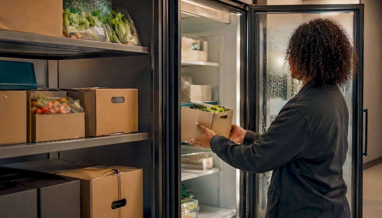 Refrigerated staging area with packages in package room