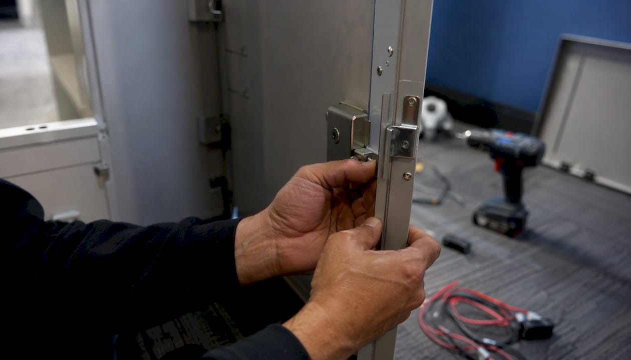 Technician hands installing electronic lockers