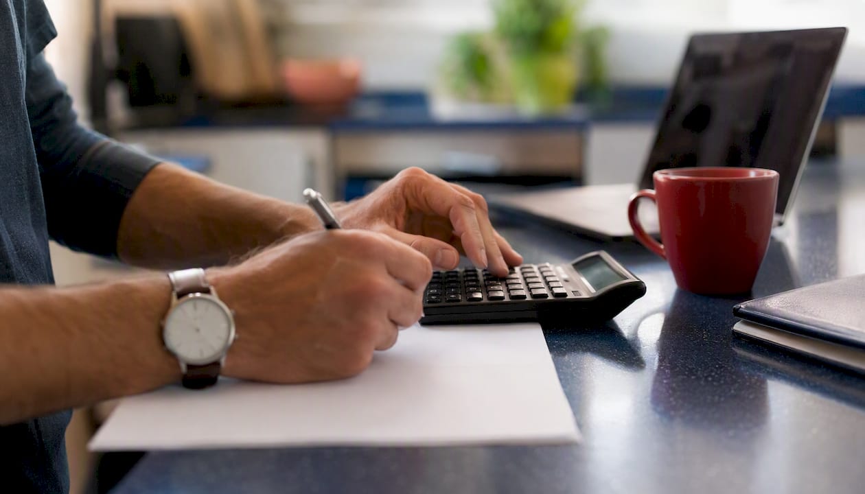Hands calculating ROI for package system