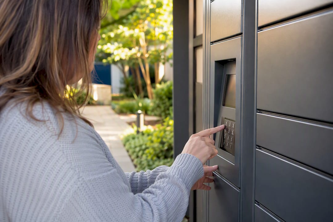 Hands entering PIN on locker keypad override
