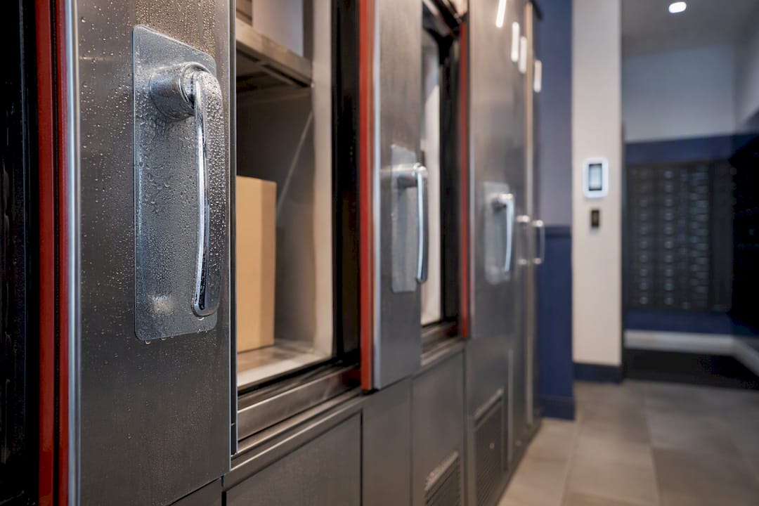 Refrigerated lockers with open compartments in apartment package room