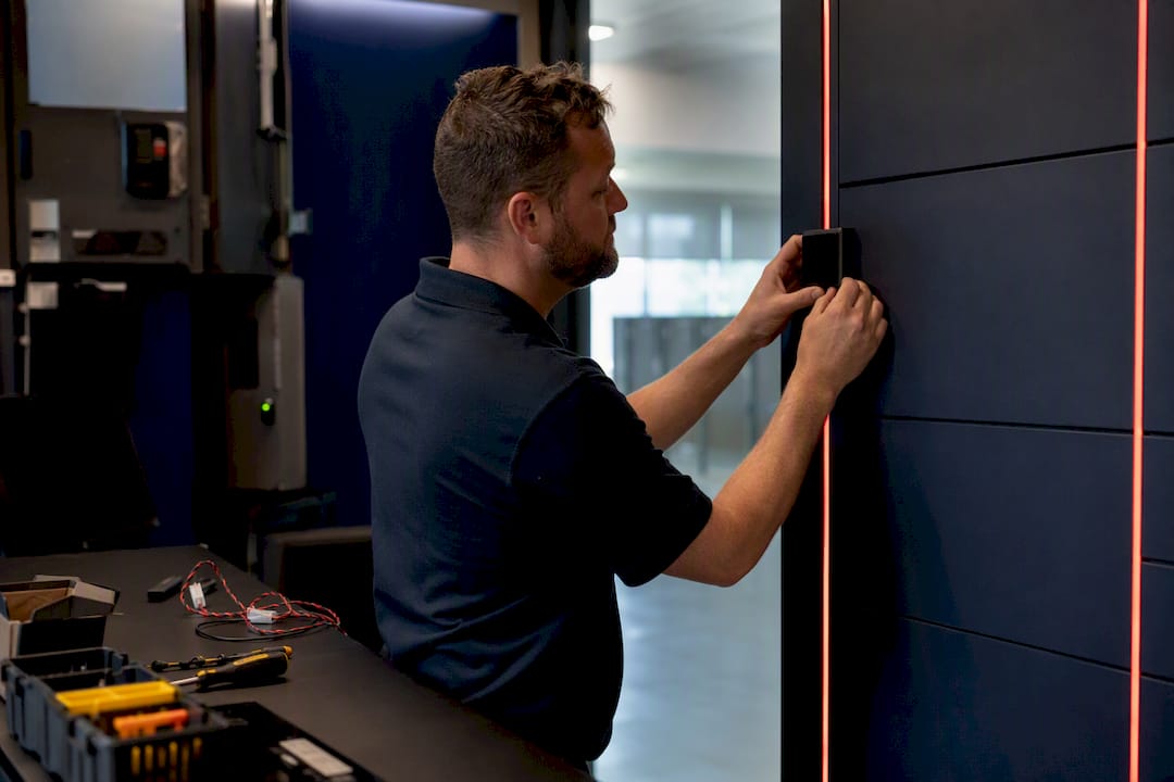 Hands installing access panel on refrigerated locker