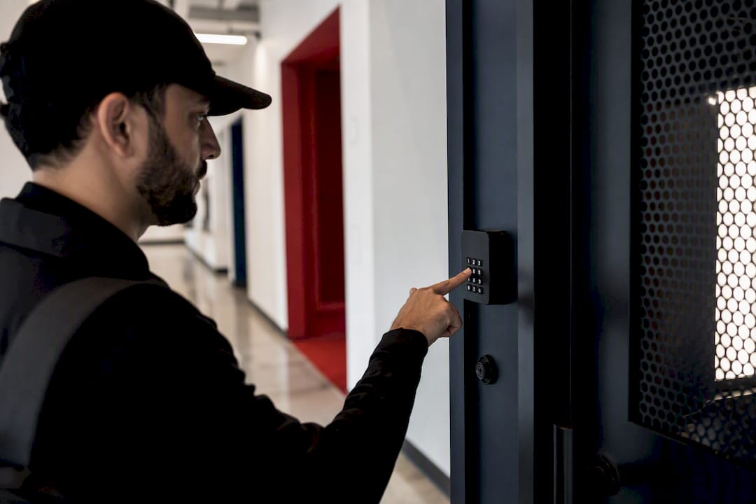 Delivery hand entering PIN on package room keypad