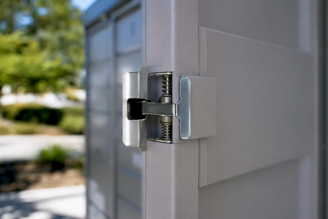 Close-up of spring-loaded parcel locker door latch