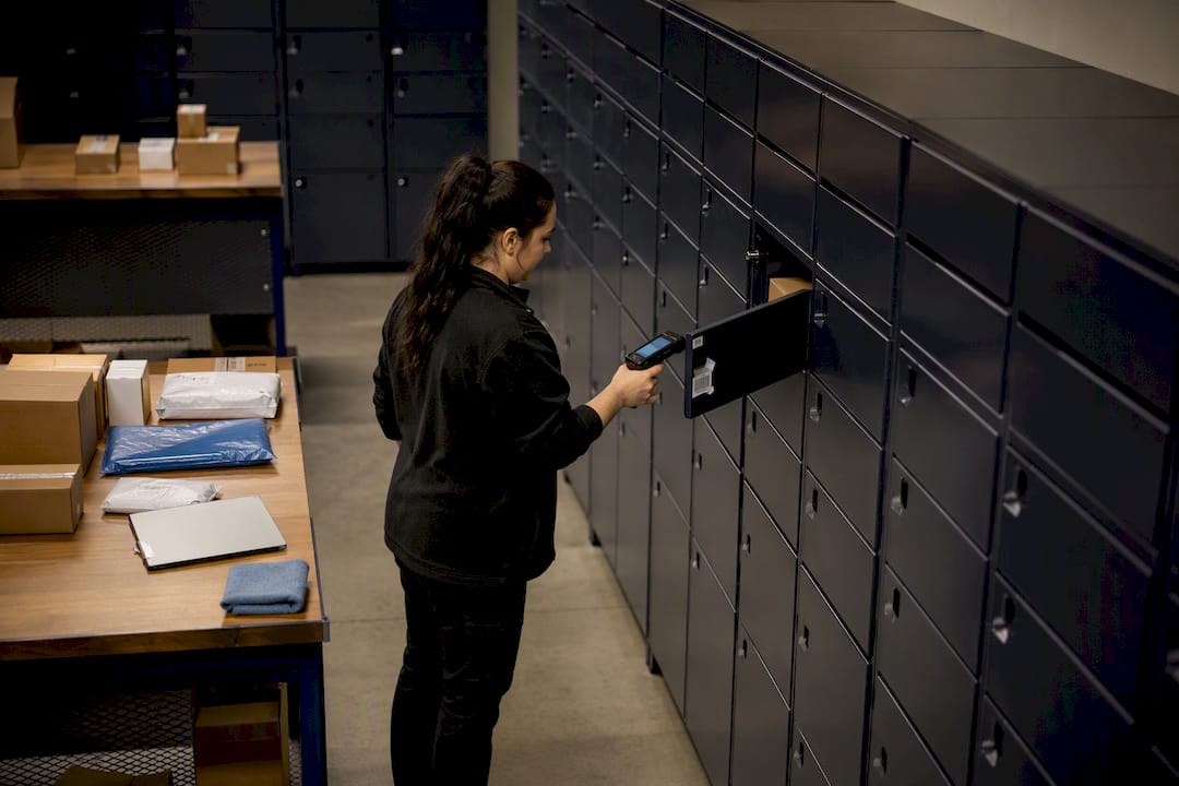 Package room with organized lockers and auditing hand