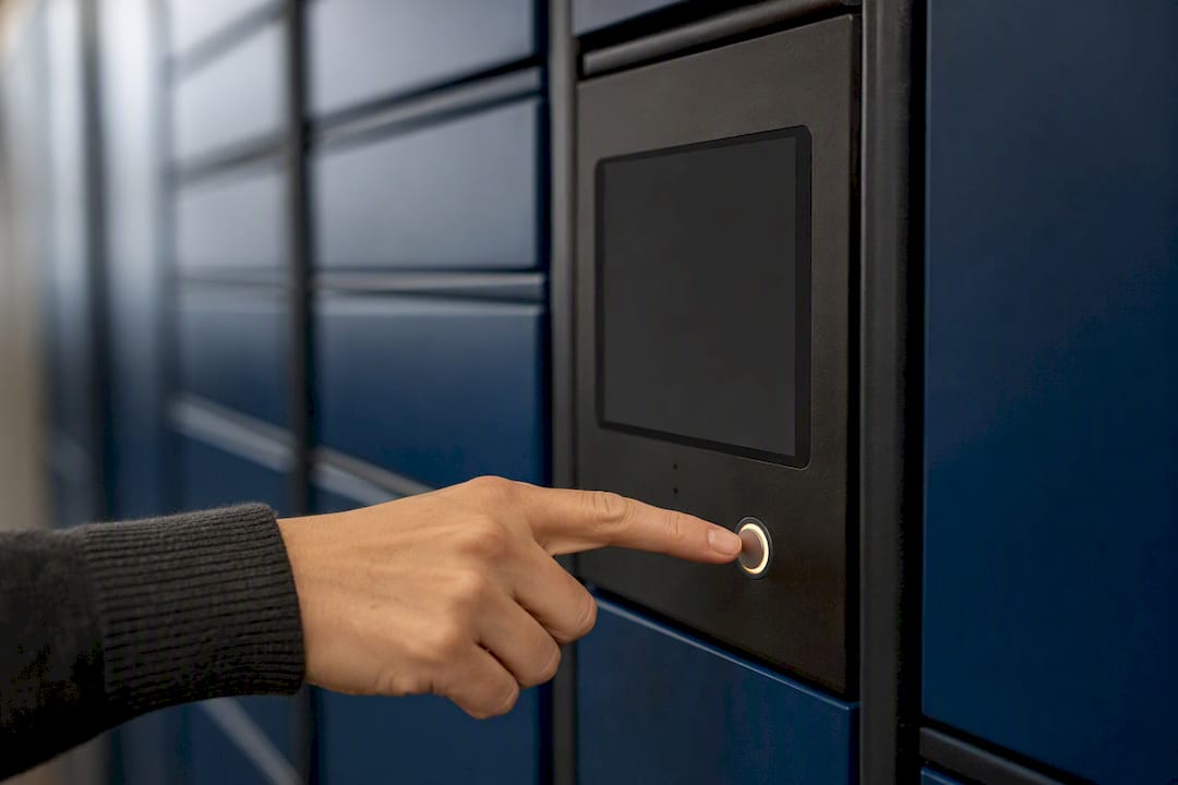 Hand pressing notification button on locker panel