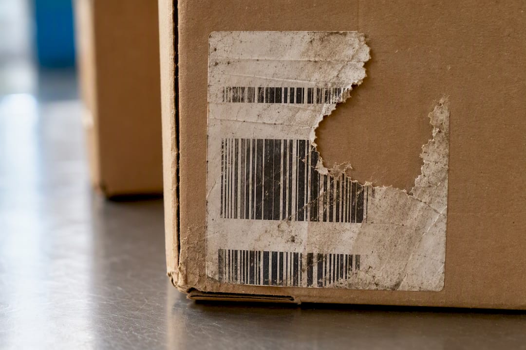 Torn parcel label on a carton
