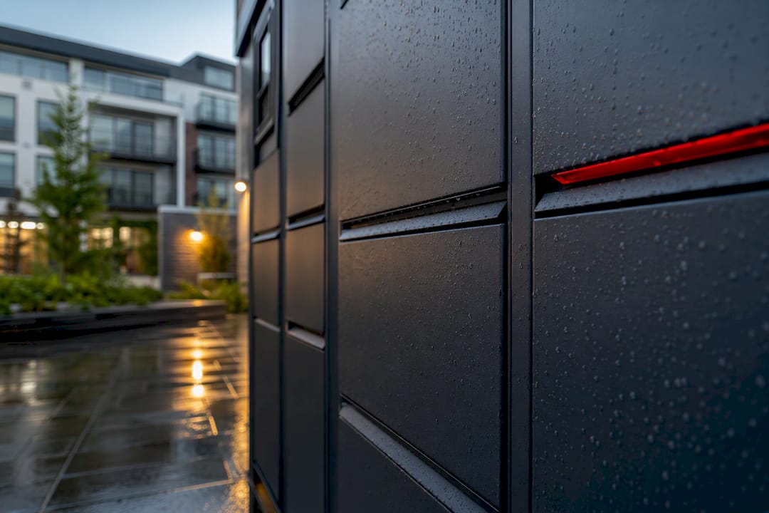 Weatherproof locker compartments outside multifamily housing