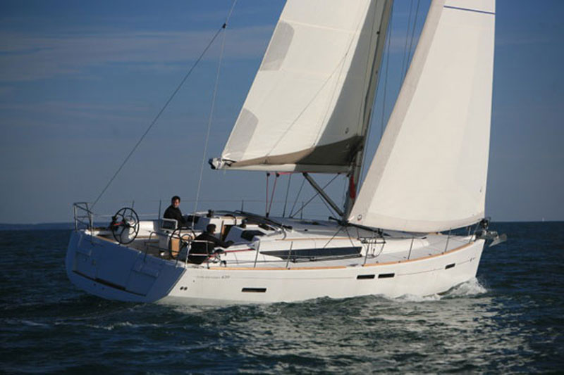 Man steering catamaran for relaxation at sea