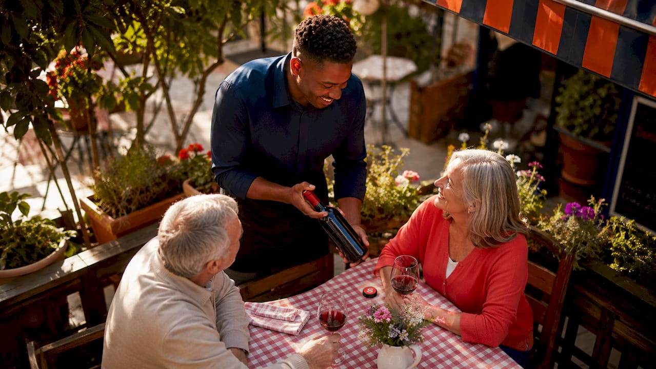 Server suggesting wine upgrade to guests
