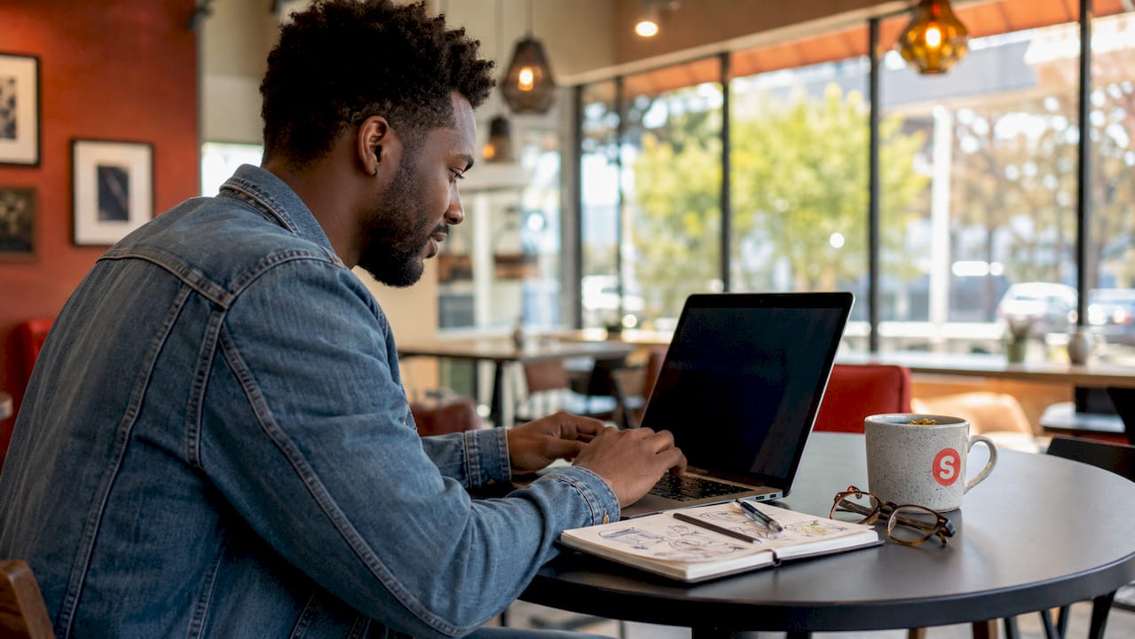 Man managing real-time marketing triggers at home office