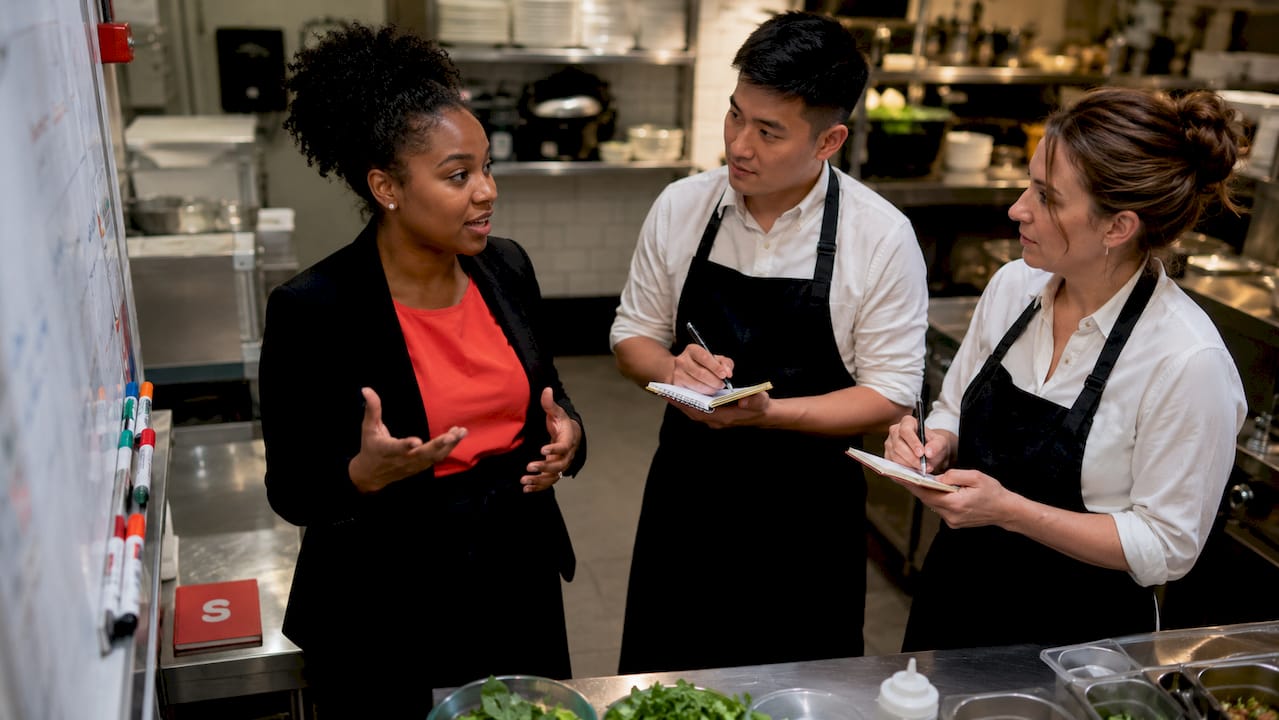 Restaurant manager briefing staff on campaign