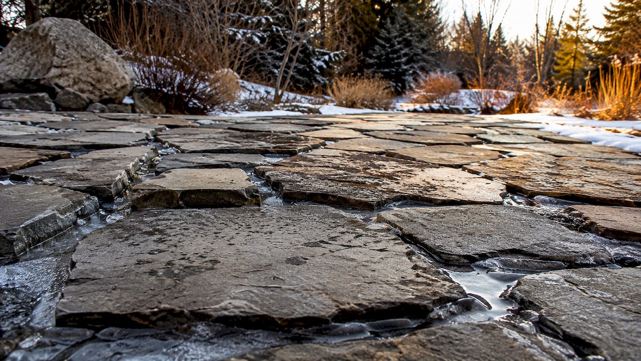 Weathered natural stone patio with frost damage