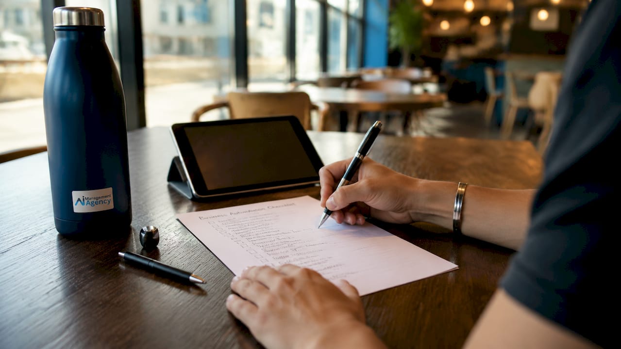 Hands holding workflow automation checklist on table