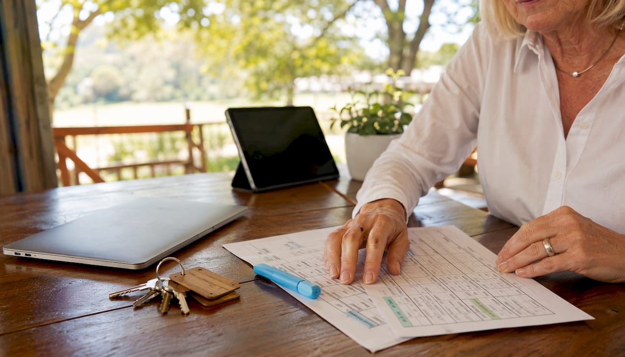 Hands typing housekeeping schedules on hotel office laptop