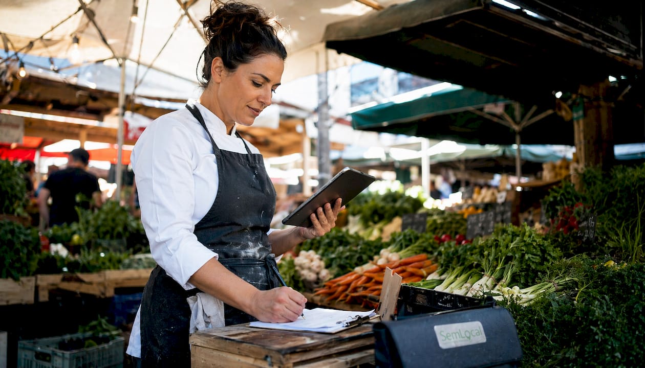 Chef using tablet for food inventory forecasting