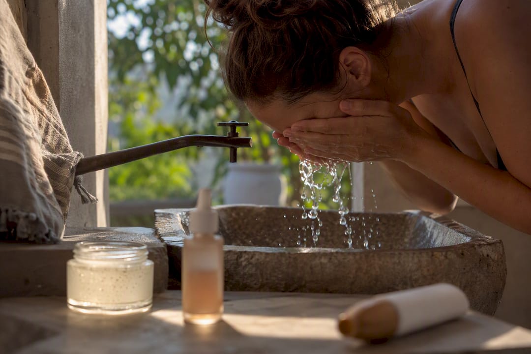 Morning skincare routine products on bathroom shelf