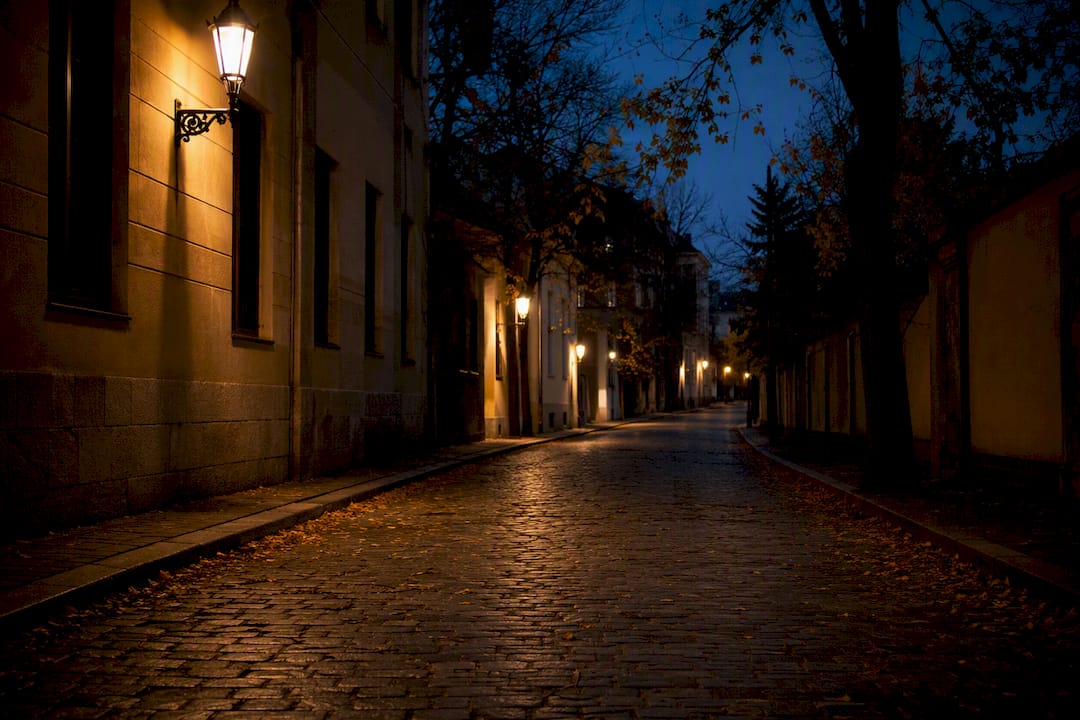 Empty dimly lit city street at dusk