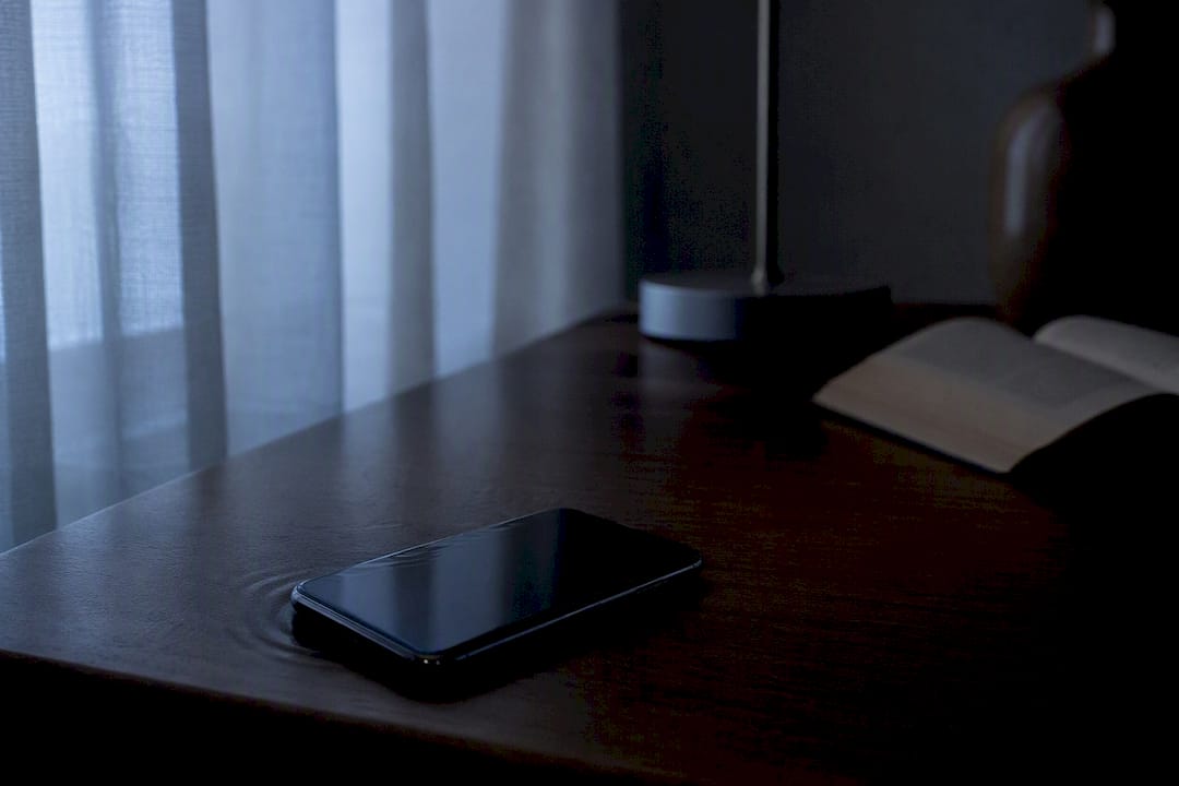 Smartphone vibrating on nightstand at night