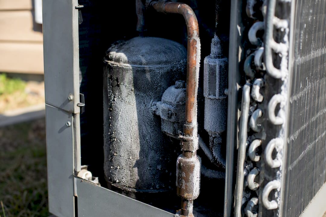 Close-up of frosted AC compressor components