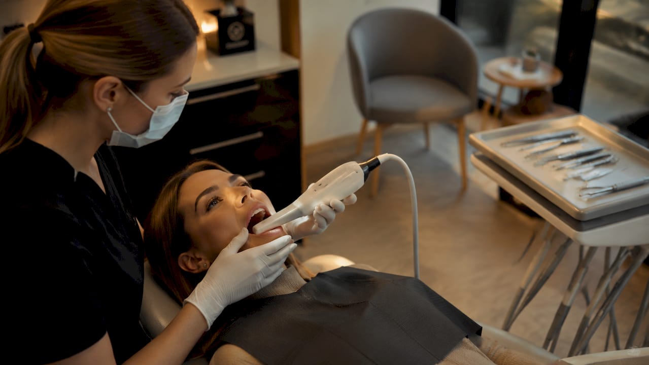 Intraoral digital scanner in use on patient