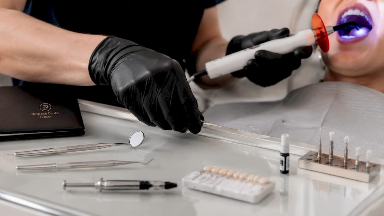 Dentist's hands preparing restorative dental tools