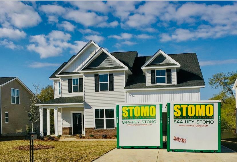 Charleston homeowner prepping portable storage container marked Hurricane Prep