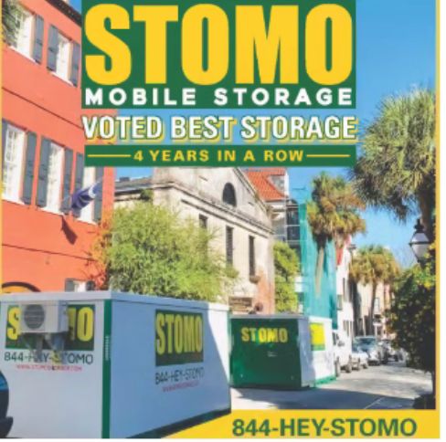 Couple loading portable storage container labeled 'Life Transitions' outside home