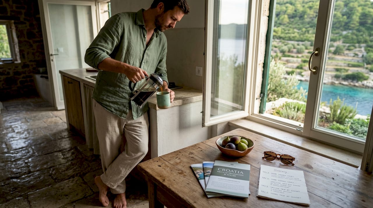 Guest making coffee in stone villa kitchen